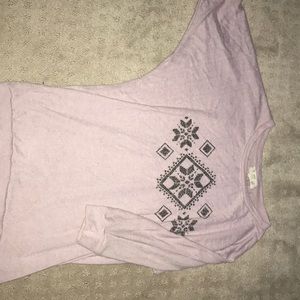 This is a blush pink shirt with a pretty design